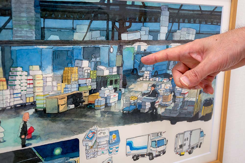 画面の隅に、築地市場に圧倒されているモリナガさん（と、アシスタントのタコ）がいる